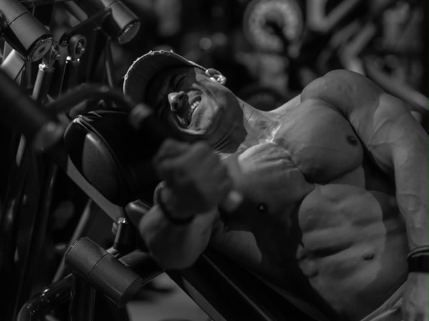 Gio Melchor training with intensity in a dramatic gym setting